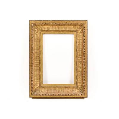 an antique gold frame on a white wall with a white background