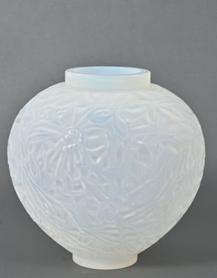 a white vase with a blue lid sitting on a table