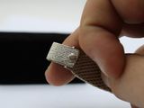 a person holding a piece of cloth with a ring on it