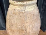 a large stone pot sitting on a wooden table