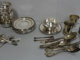 a lot of silverware sitting on a table