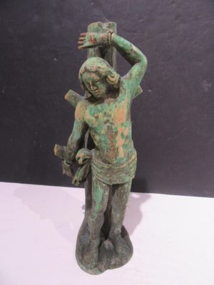 bronze figurine of a man holding a bird on his shoulder