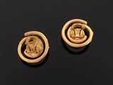 a pair of gold earrings depicting a woman and a man