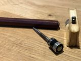 a hammer and a pencil sitting on a wooden table