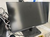 a computer monitor sitting on top of a desk