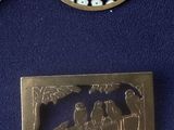 three pieces of jewelry including a broochle, a pendant, and a broochele
