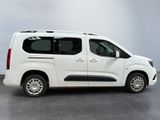 the white van is parked in a room with a gray floor