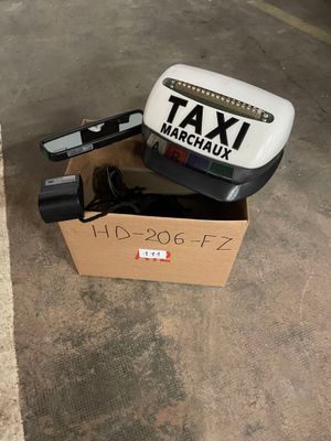 a box with a taxi sign on it sitting on the ground