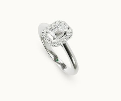 an emerald and diamond ring on a white background
