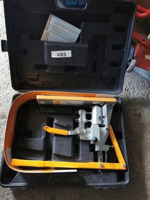 a tool in the case that is sitting on the floor