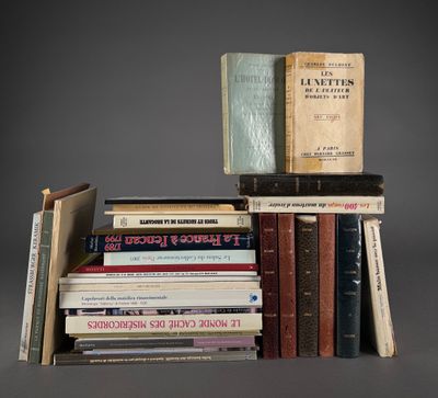 several books are stacked on top of each other on a gray surface
