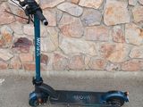 a scooter that is sitting on the sidewalk
