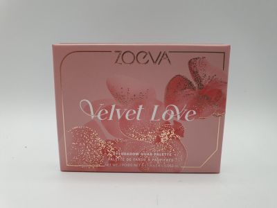 a close up of a box of perfume on a white surface