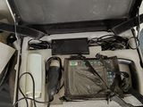 a suitcase that has a laptop and other electronics inside of it