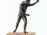 bronze statue of a man holding a tennis racquet on a marble base
