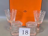 four glasses and an orange box are sitting on a table