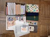 a box full of stamps and envelopes on the floor
