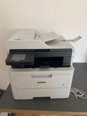 a printer sitting on top of a table with a charger