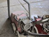 a machine that is sitting on the ground in the garage