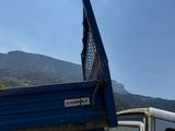 a truck that has its door open on the side of the road