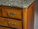 a marble top chest of drawers with a marble top