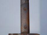 a close up of a knife on a wooden stand