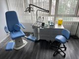 a dentist ' s chair in the corner of the room