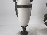 two white vases sitting on top of a white pedestal
