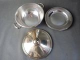 three pieces of silverware sitting on top of a table