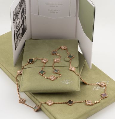 an open book with a picture of a necklace and bracelet on it
