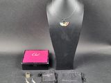 a necklace, bracelet, and other items on a mannequin