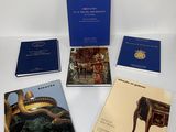 four books are sitting on a white table with blue covers