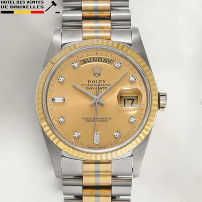 a gold and silver rolex watch with diamonds on the dial