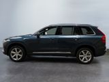 the blue volvo suv is parked in a large room