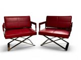 pair of red leather lounge chairs with chrome legs and arms