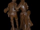bronze statue of a man and a woman standing next to each other