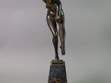 a statue of a woman holding a cup on a marble base