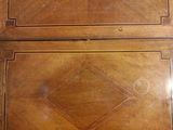 a wooden cabinet that has two drawers on top of it