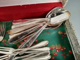 a tray with silverware on it with a red cloth