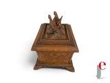 a small wooden box with a statue of a bird on it