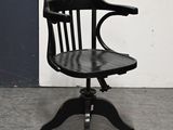 a black chair with a wooden seat on a metal stand
