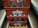 a stack of crates that have soda bottles in them