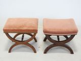 a pair of stools with a pink upholstered seat