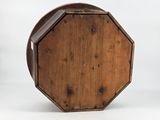 an old wooden octagonal table with a glass top on a white background