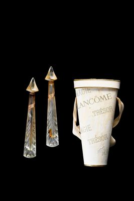 two vases that are next to each other on a black background
