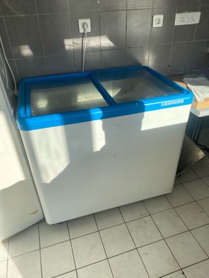 a white and blue washing machine in a bathroom