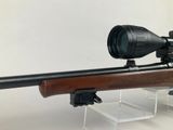 a close up of a rifle with a scope mounted on it