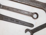 a lot of wrenches that are laying on a table