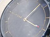 a close up of a watch with a black face