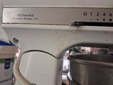 a white kitchen aid mixer sitting on top of a kitchen counter